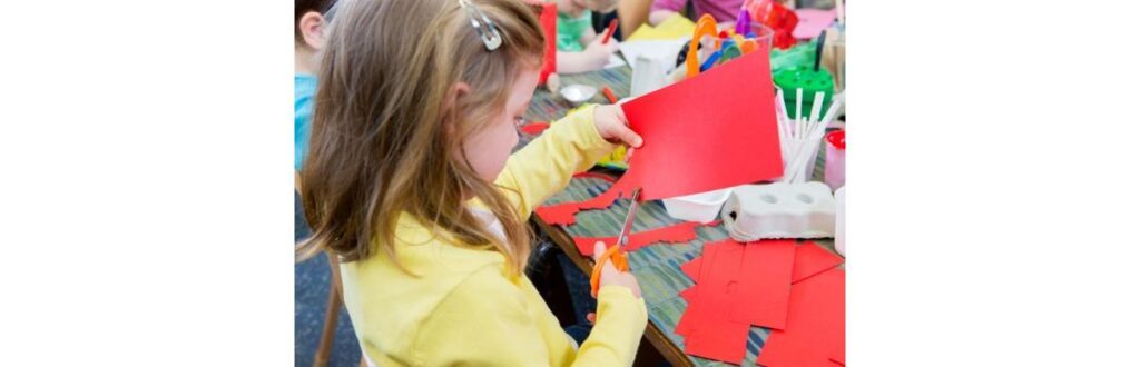 little-girl-cutting-paper-picture-id544351506