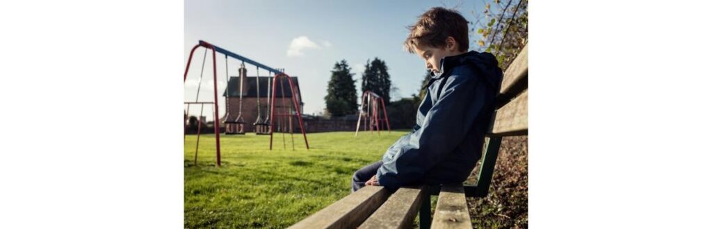 lonely-child-sitting-on-play-park-playground-bench-picture-id505065748