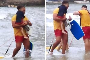 Bombeiro com criança nos braços, enxugando as lágrimas ao salvá-la