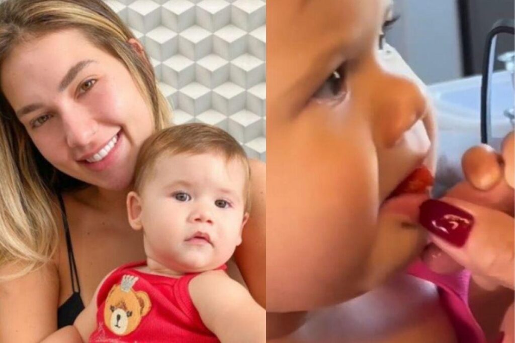 Maria Alice experimentando morango pela primeira vez