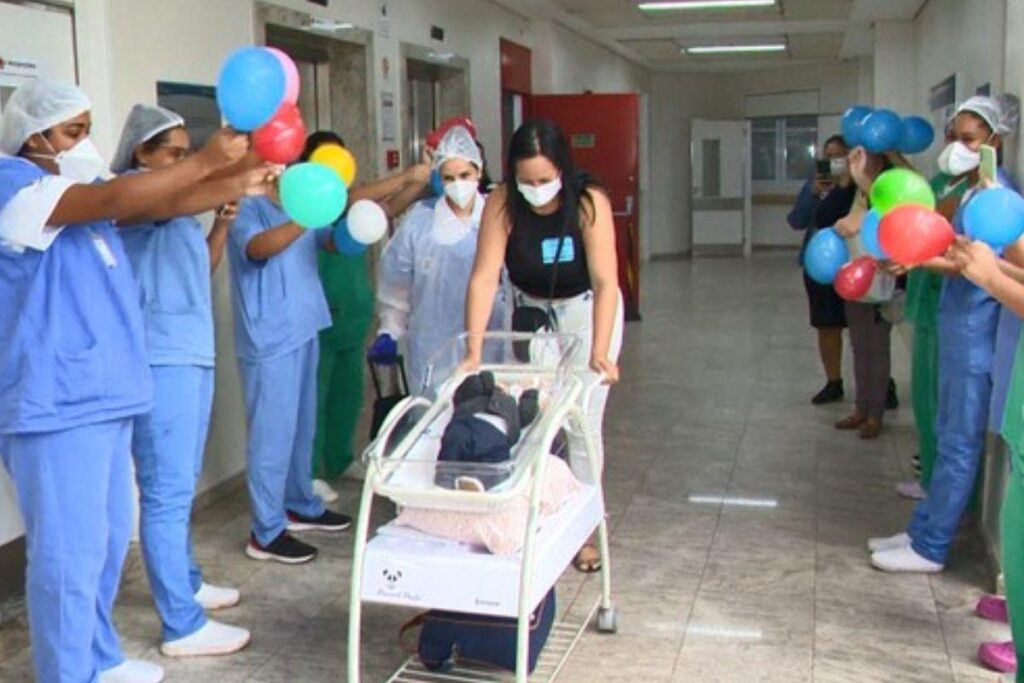 Kamila Garajau segurando o filho Heitor, o qual nasceu com má-formação e foi curado