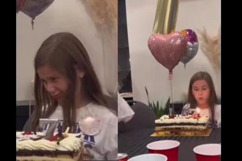 Menina apaga a vela do aniversário da irmã mais velha