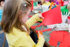 little-girl-cutting-paper-picture-id544351506