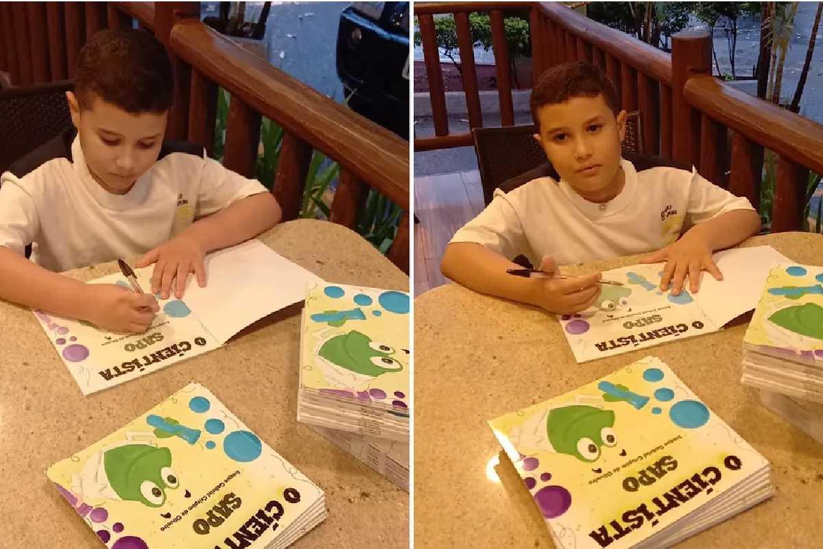 Criança autografando livro que escreveu