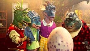 Personagens de Família Dinossauros olhando para um ovo.