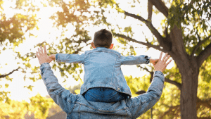 Homem com uma criança nos ombros