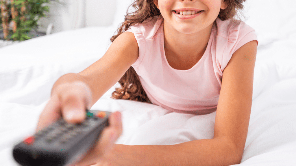 Criança segurando um controle na mão e sorrindo